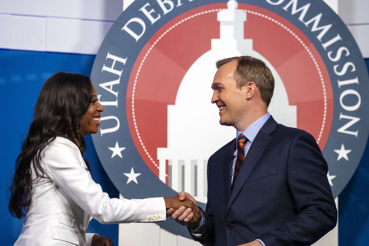FILE - U.S. Rep. Mia Love and Salt Lake County Mayor Ben McAdams shake hands as they take part in a debate at the Gail Miller Conference Center at Salt Lake Community College on Monday, Oct. 15, 2018, in Sandy, Utah, as the two battle for Utah's 4th Congr