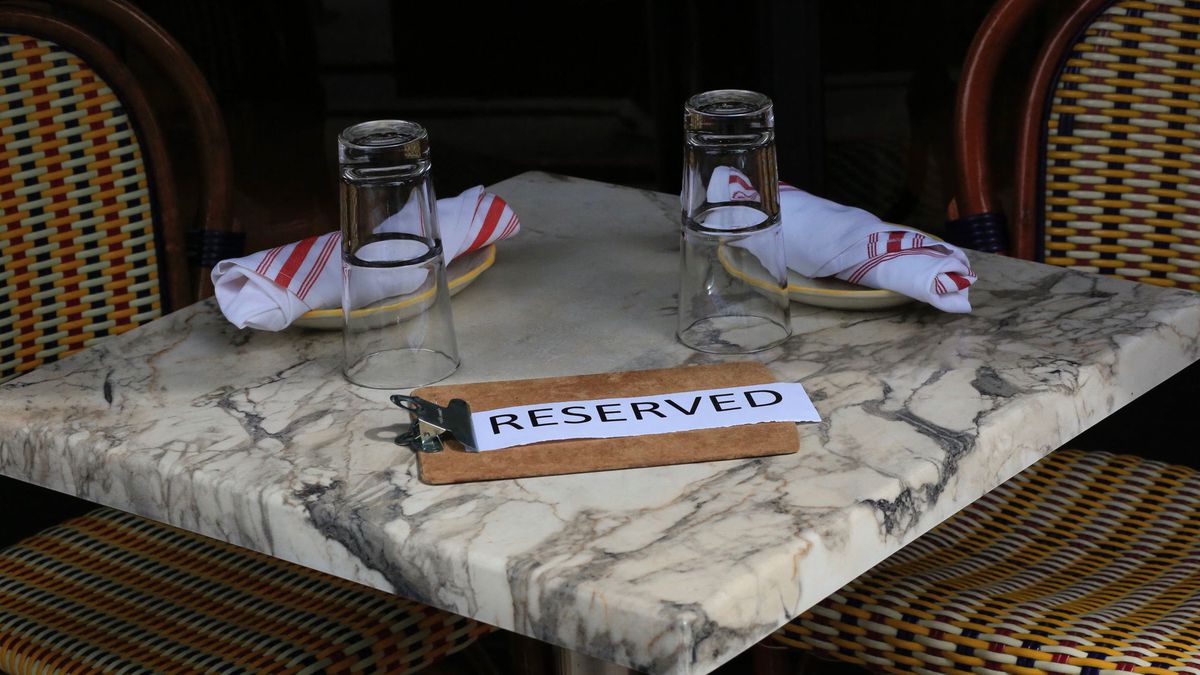 A sign with the words “reserved” is placed on a granite countertop at a Manhattan restaurant.