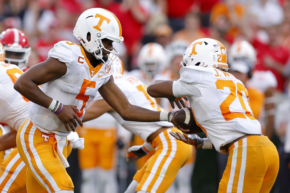 Hendon Hooker of the Tennessee Volunteers hands off the ball to Jaylen Wright of the Tennessee Volunteers during the third quarter against the Georgia Bulldogsat Sanford Stadium on November 05, 2022 in Athens, Georgia.
