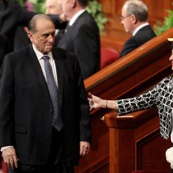 Sister Harriet Uchtdorf reaches out to President Thomas S. Monson as he leaves the afternoon session of the 183rd Annual General Conference of The Church of Jesus Christ of Latter-day Saints in the Conference Center in Salt Lake City on Sunday, April 7, 2013. 