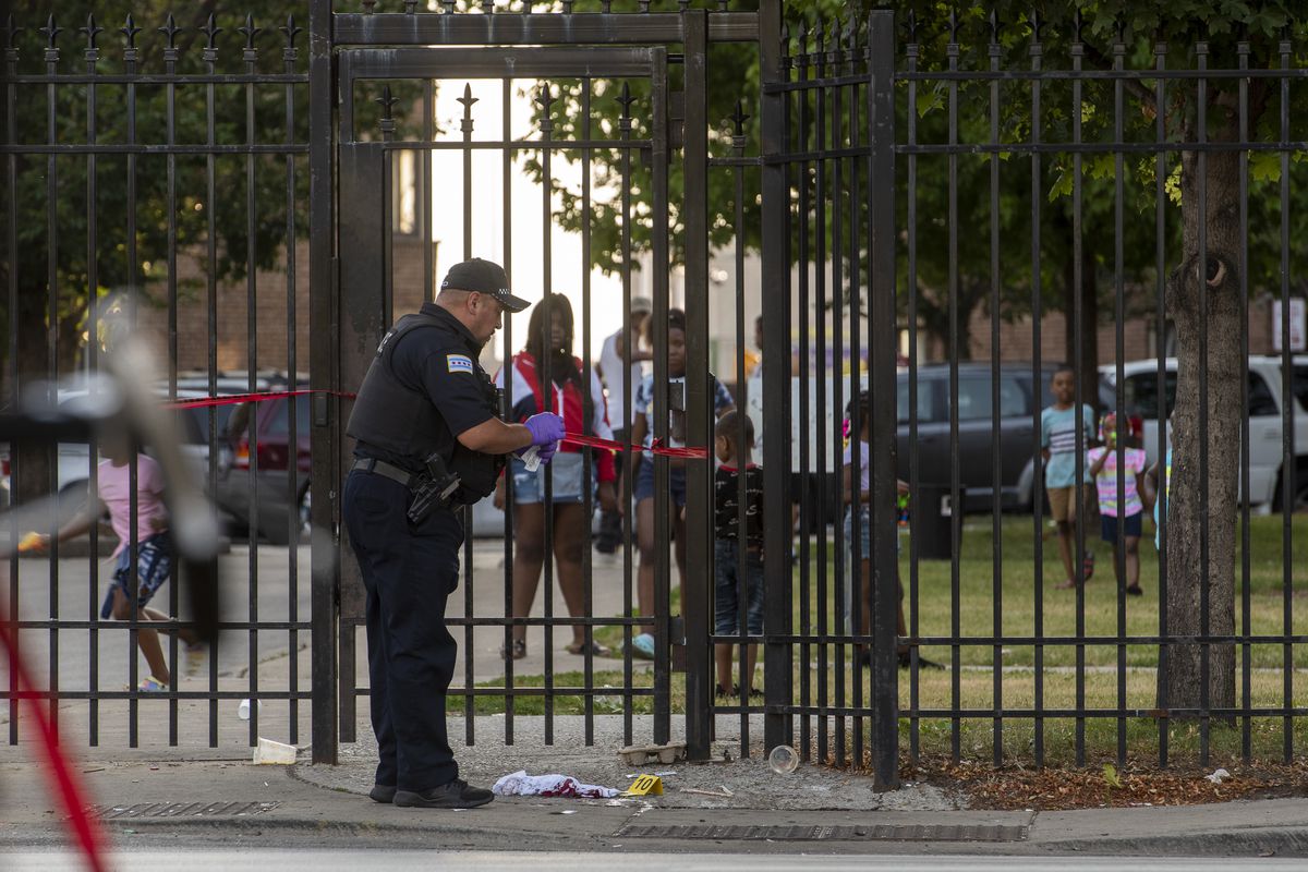 Chicago police work the scene where a person was shot and killed in the 6400 block of South King Drive, in the Parkway Gardens neighborhood, Friday, June 18, 2021. 