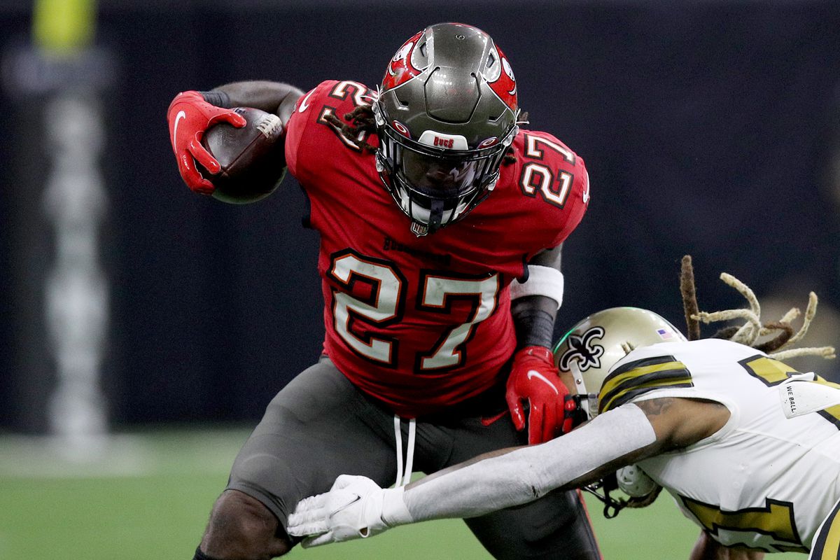 Ronald Jones #27 of the Tampa Bay Buccaneers runs the ball and is tackled by Bradley Roby #21 of the New Orleans Saints during the second half at Caesars Superdome on October 31, 2021 in New Orleans, Louisiana.