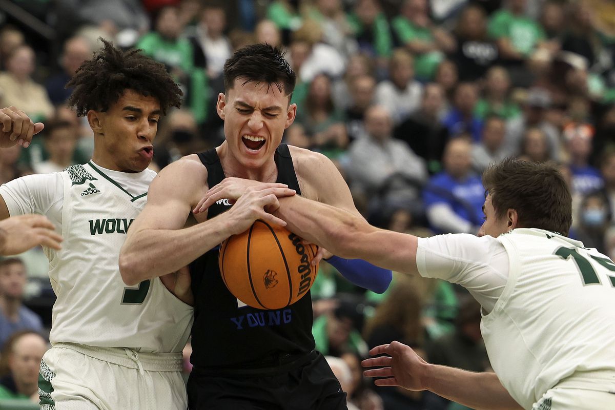 Brigham Young Cougars guard Alex Barcello (13) is stopped by Utah Valley Wolverines guard Blaze Nield (3) and Utah Valley Wolverines guard Connor Harding (15) at Utah Valley University in Orem on Wednesday, Dec. 1, 2021.
