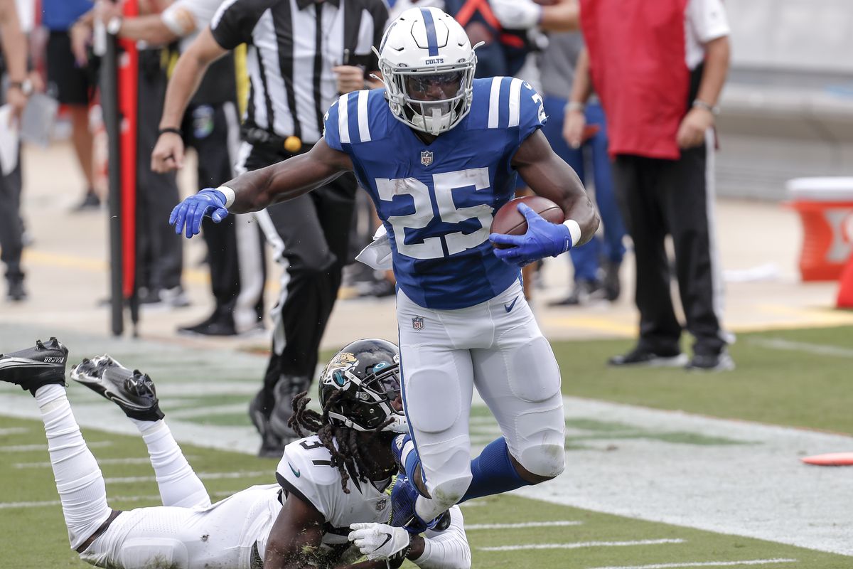 Running back Marlon Mack of the Indianapolis Colts is tackled from behind by Cornerback Tre Herndon #37 of the Jacksonville Jaguars during the game at TIAA Bank Field on September 13, 2020 in Jacksonville, Florida.
