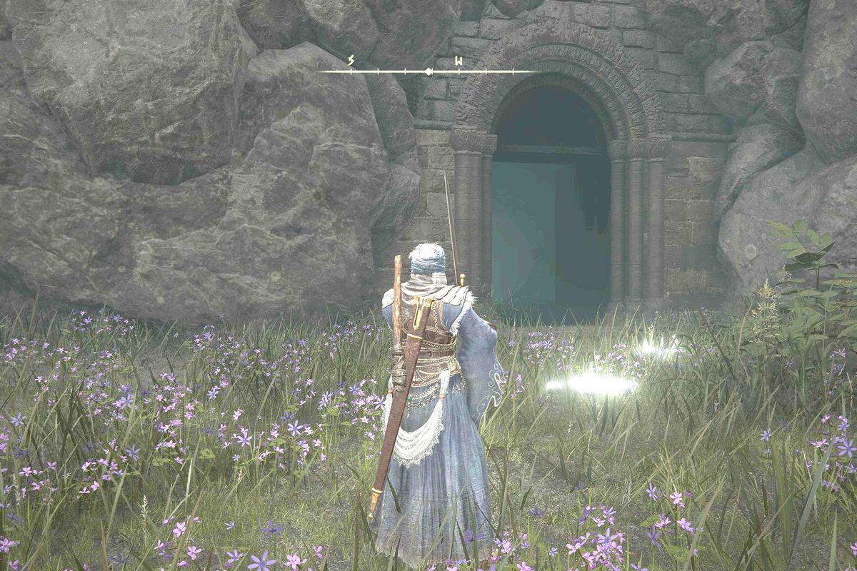 Standing outside of the entrance to Murkwater Catacombs in Elden Ring