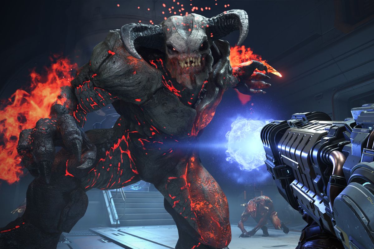 a huge, horned demon covered in flames leers over the player in Doom Eternal