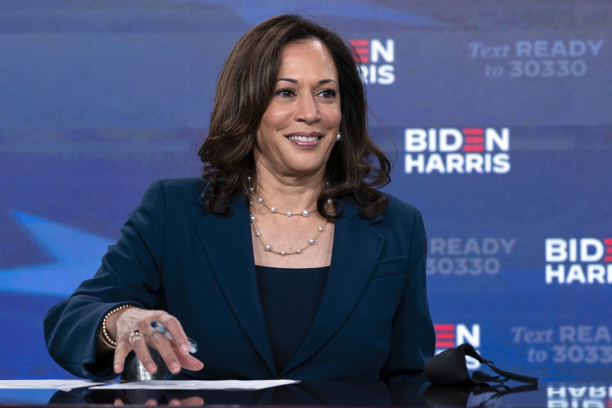 Democratic presidential candidate former Vice President Joe Biden’s running mate Sen. Kamala Harris, D-Calif., looks up as she signs required documents for receiving the Democratic nomination for President and Vice President of the United States in Wilmington, Del., Friday, Aug. 14,