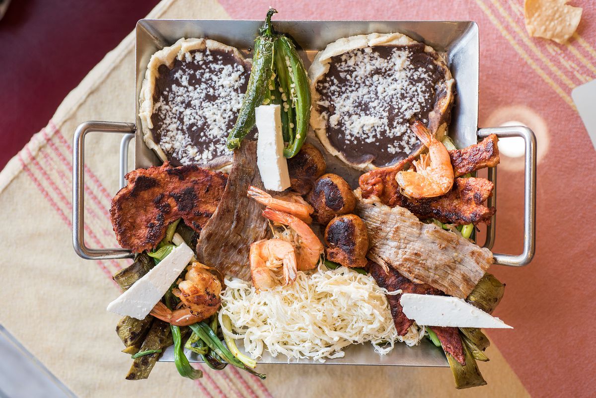 Parrillada, an array of grilled meats and sopes at Las 7 Regiones in Los Angeles.