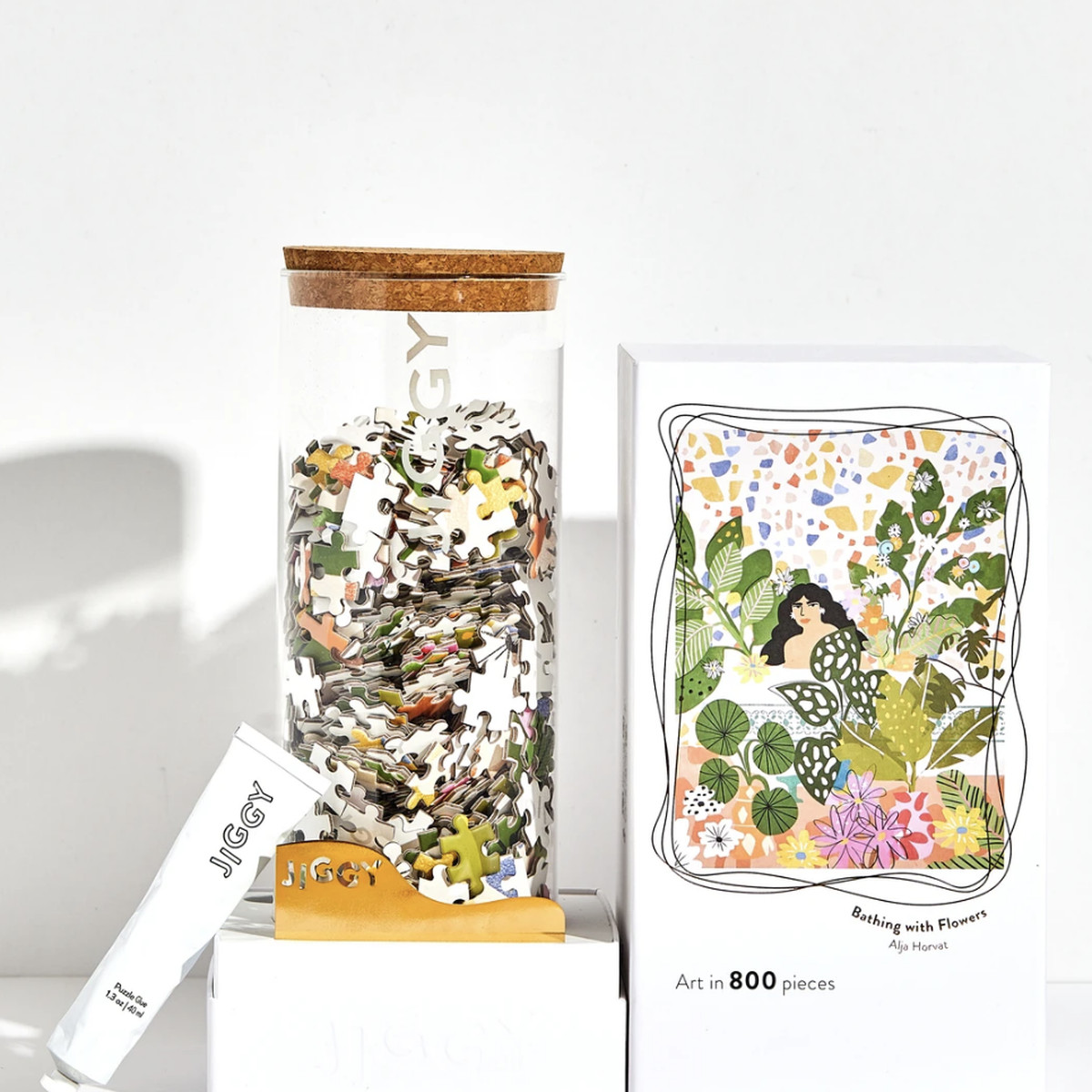 The box and pieces for a Jiggy “Bathing With Flowers” puzzle