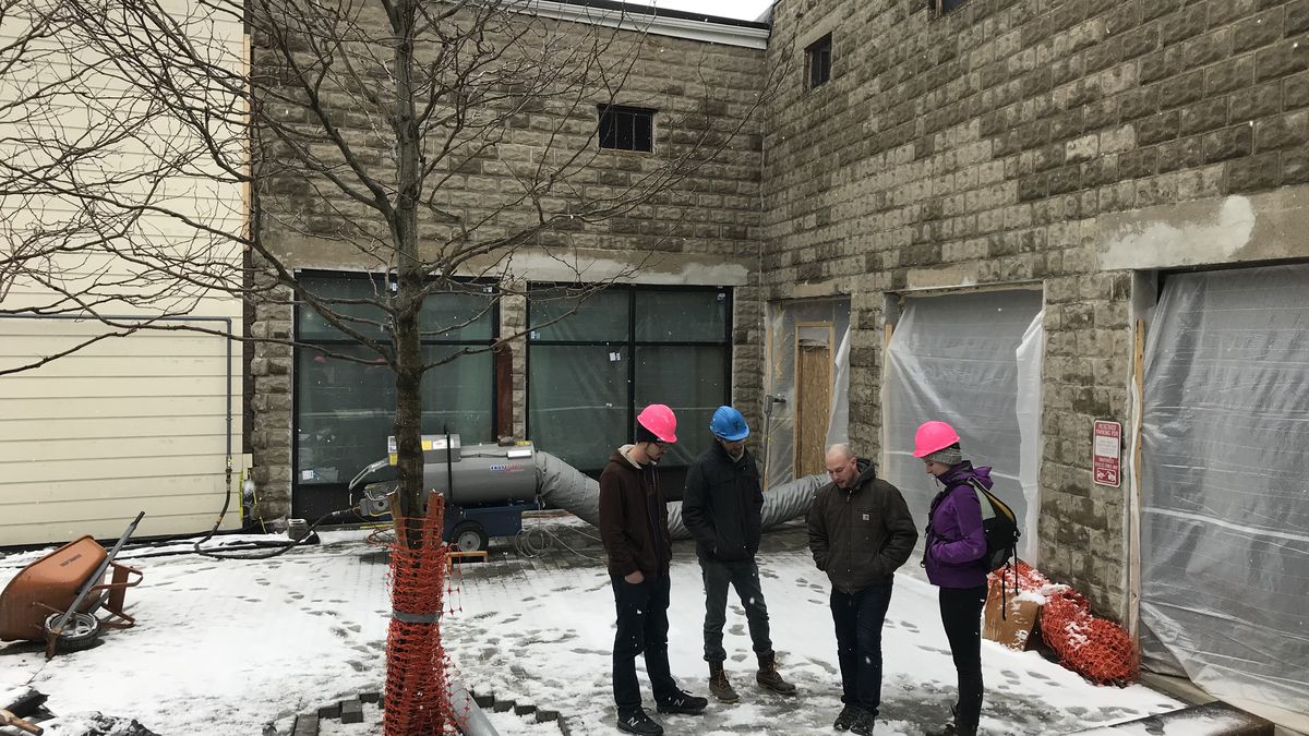 The Remnant Brewing team discussing plans in their upcoming biergarten. (Left to right: head brewer Charlie Cummings, cofounder Joel Prickett, cofounder David Kushner, and general manager Brittany Lajoie)