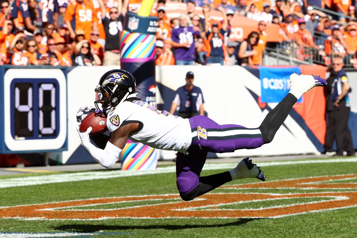 Marquise Brown #5 of the Baltimore Ravens snags a touchdown catch against the Denver Broncos at Empower Field At Mile High on October 3, 2021 in Denver, Colorado.