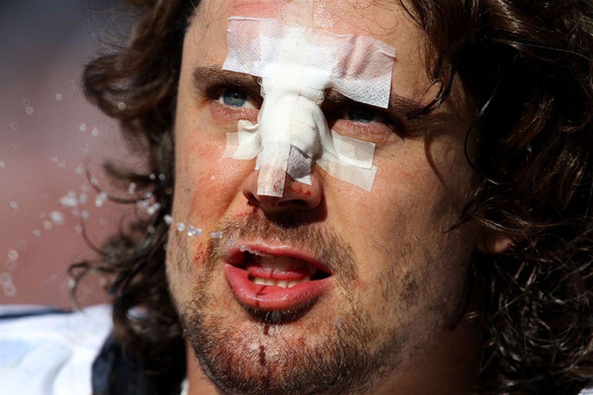 Ben Hamilton of the Seattle Seahawks spits out water on the sidelines after breaking his nose against the Chicago Bears at Soldier Field on October 17 2010 in Chicago Illinois. (Photo by Jonathan Daniel/Getty Images)