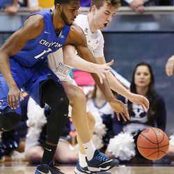 Brigham Young Cougars guard Zac Seljaas (2) and Creighton Bluejays forward Cole Huff (13) scramble for the ball as BYU and Creighton play in NIT quarterfinal action at the Marriott Center in Provo Tuesday, March 22, 2016.