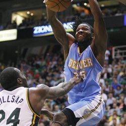 Denver's Kenneth Faried dunks over Utah's Paul Millsap as the Jazz and the Denver Nuggets play Wednesday, April 3, 2013 in Salt Lake City at Energy Solutions arena. EnergySolutions Arena. Denver beat the Jazz 113-96.
