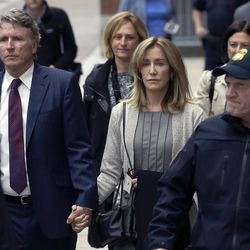 Felicity Huffman, center, departs federal court with her brother Moore Huffman Jr., left, Monday, May 13, 2019, in Boston, where she pleaded guilty to charges in a nationwide college admissions bribery scandal. (AP Photo/Steven Senne)
