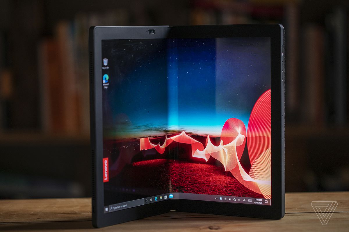 The Lenovo ThinkPad X1 Fold stands on a table in book mode.