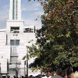 Attendees wait in line on Temple Square during LDS Church Conference in Salt Lake City  Saturday, Oct. 1, 2011. 