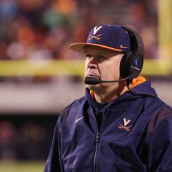 Virginia Cavalier coach Bronco Mendenhall watches a play during a game with Notre Dame in Charlottesville, Va., on Thursday Nov 13, 2021. Mendenhall is stepping down as coach.