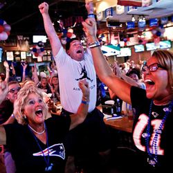 Boston natives Karen Dugan, from left, John Dugan, and Lisa Doyle celebrate as the New England Patriots scored their second touchdown against the Seattle Seahawks before halftime in the Super Bowl while they watched with their fellow Patriot fans at Foxboro Sports Tavern in East Naples, Fla., on Sunday, Feb. 1, 2015.