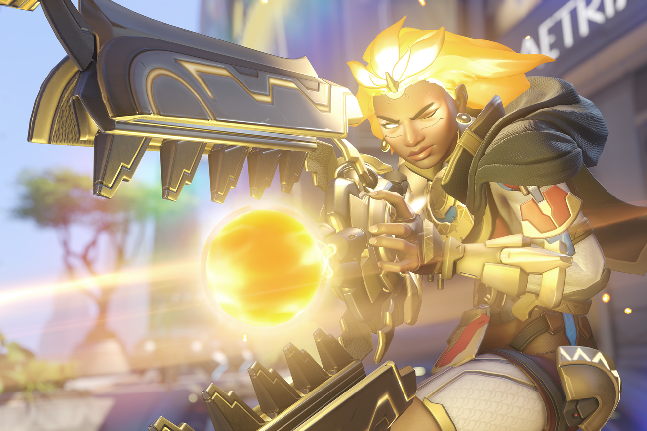 Screenshot from Overwatch 2 featuring the new support hero Illari, her hair glowing gold as she unleashes  her ultimate Captive Sun