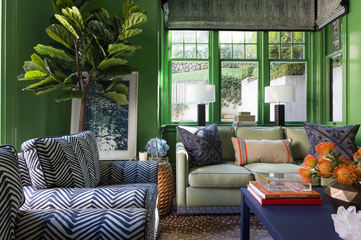 A living room where every bit of every wall is painted green.