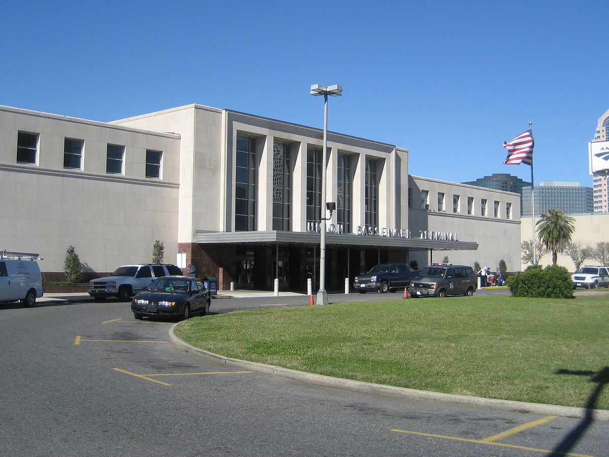 Union Passenger Terminal in New Orleans includes a main concrete entrance with a driveway and green lawn.