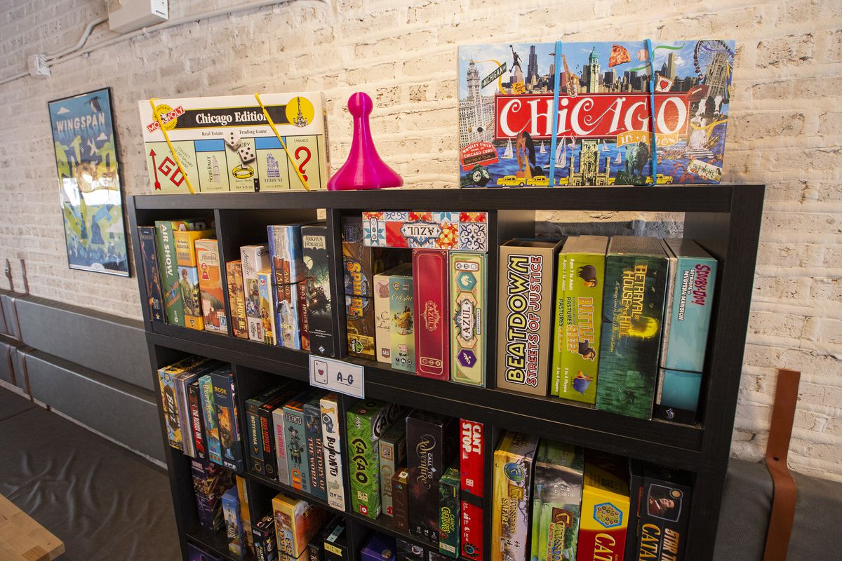 A black shelving unit is filled with colorful board game boxes.