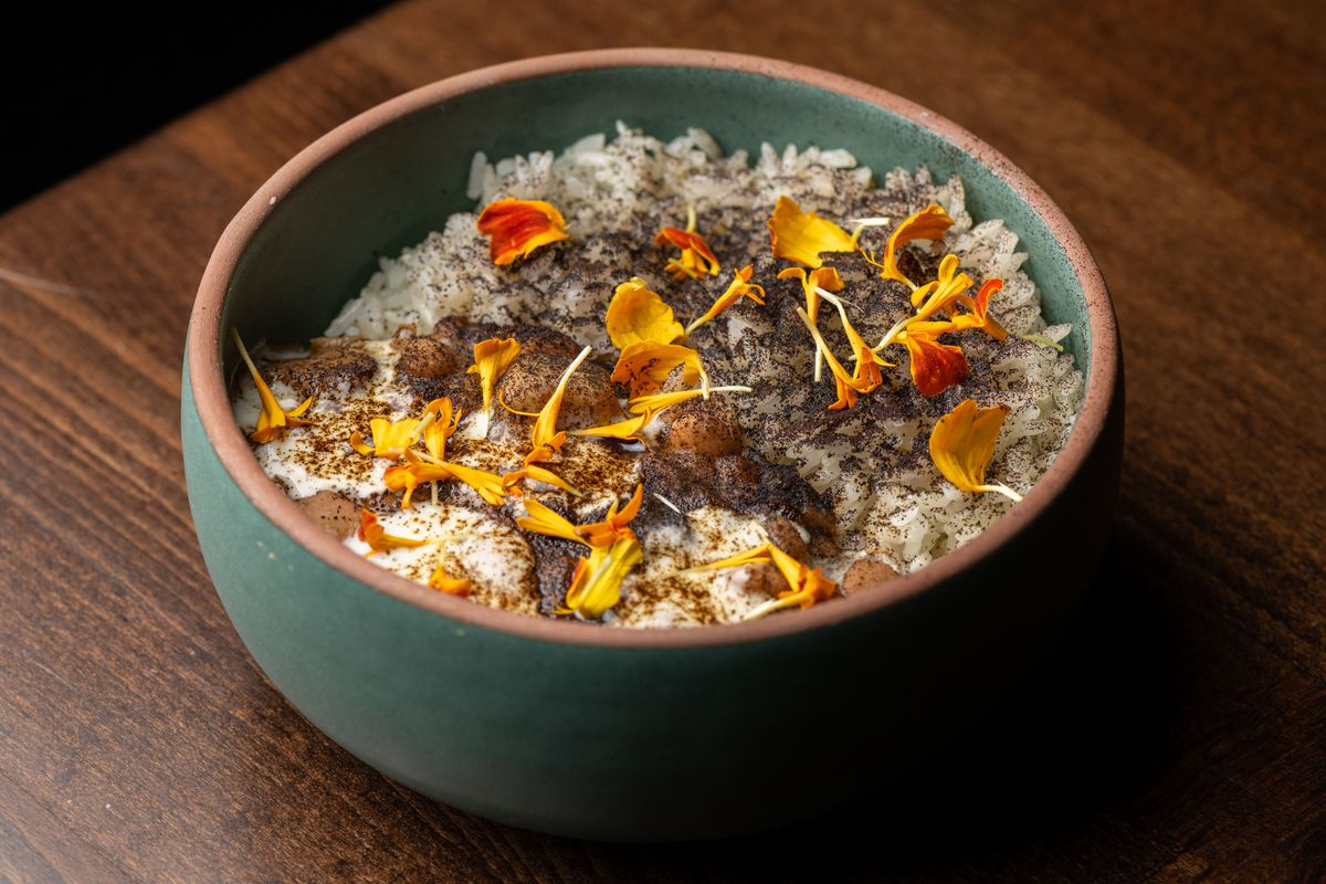 A small bowl of rice and beans with flowers.