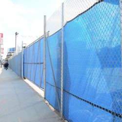 Construction fence on Clark Street, in front of the former McDonald's property -