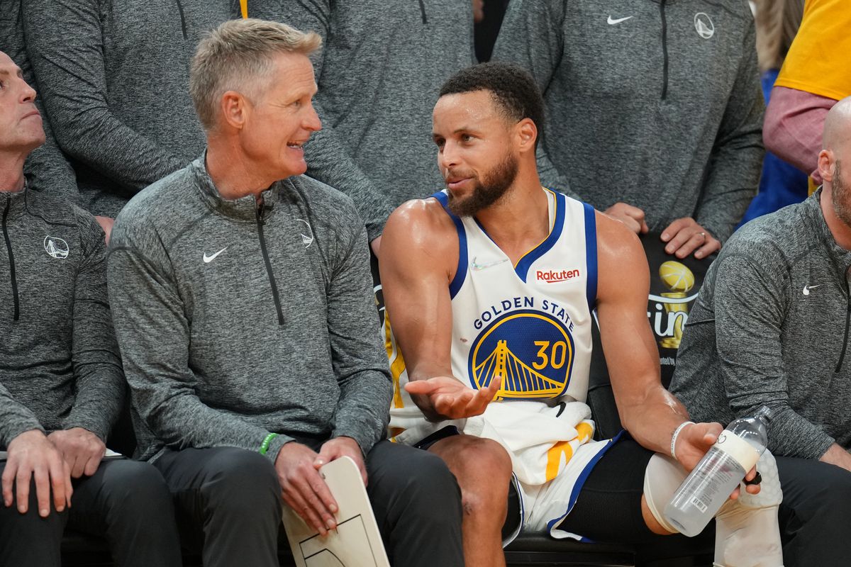 Steph Curry talks to Steve Kerr on the bench 