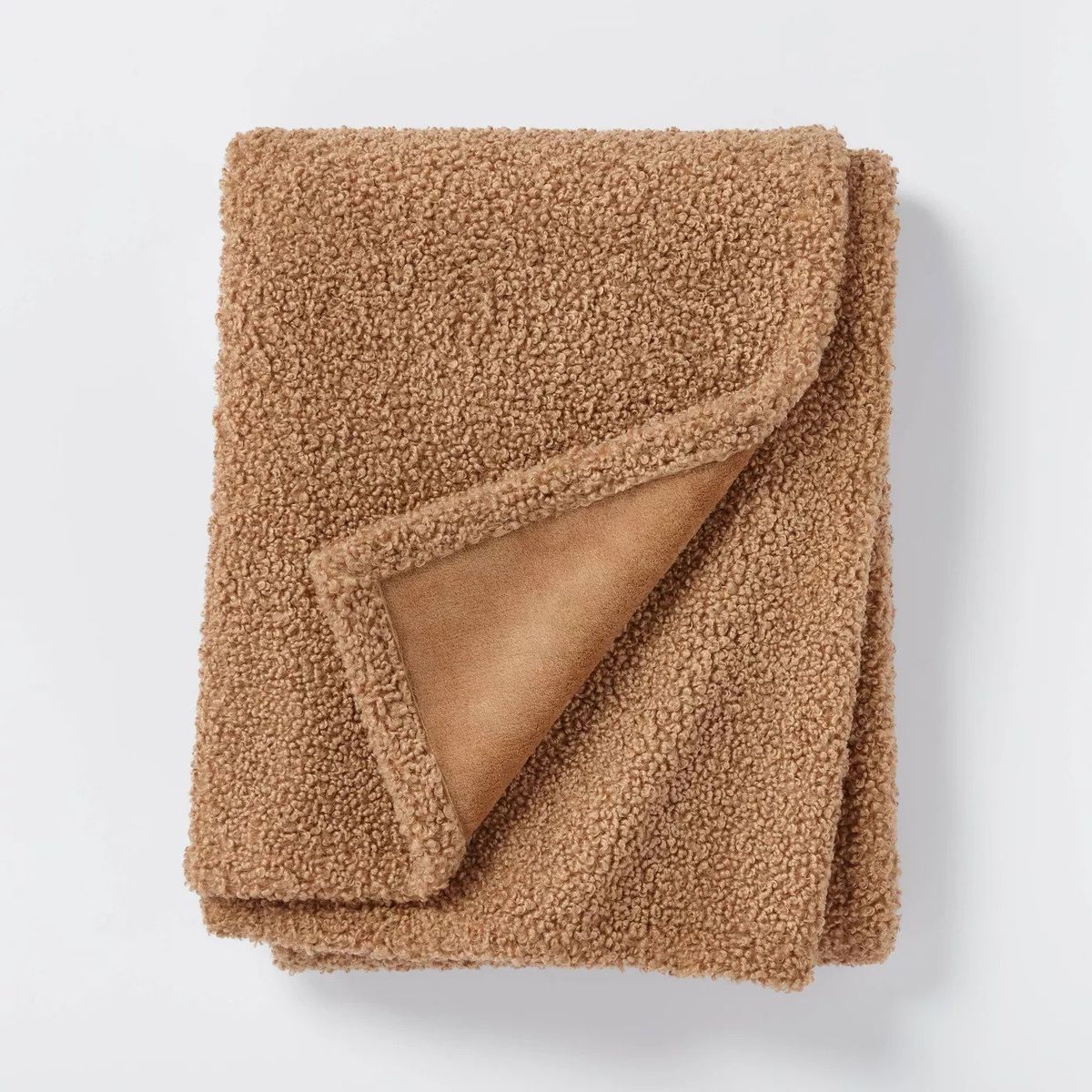 A boucle blanket in a camel color