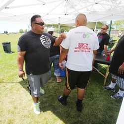 Alema Te'o (left), the founder and administrator of the All Poly Camp, walks around Monday, June 17, 2013 in Layton. Te'o uses the football camp to teach young people about education and community.