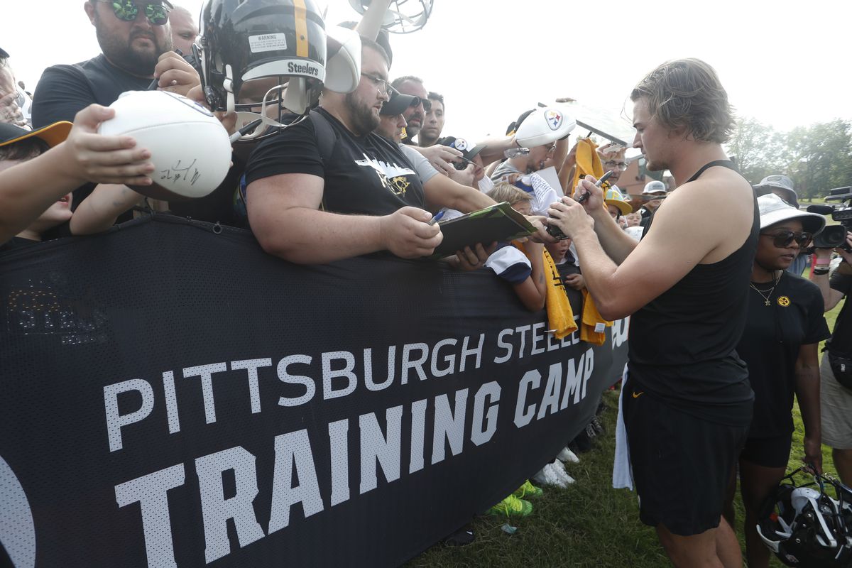 Steelers quarterback Kenny Pickett (8) signs autographs during training camp at Saint Vincent College. Mandatory Credit: Charles LeClaire