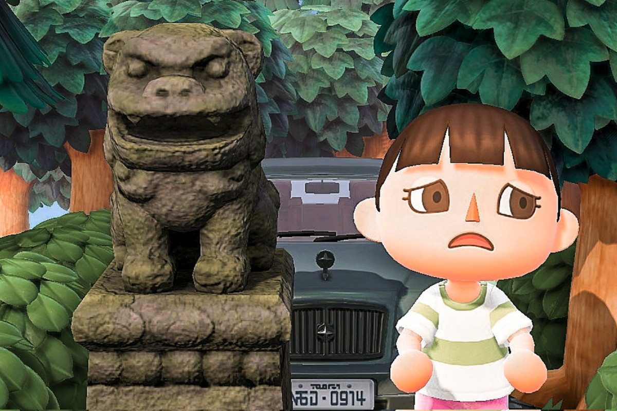 A recreation of Spirited Away’s Chihiro standing next to a stone dog, in Animal Crossing: New Horizons
