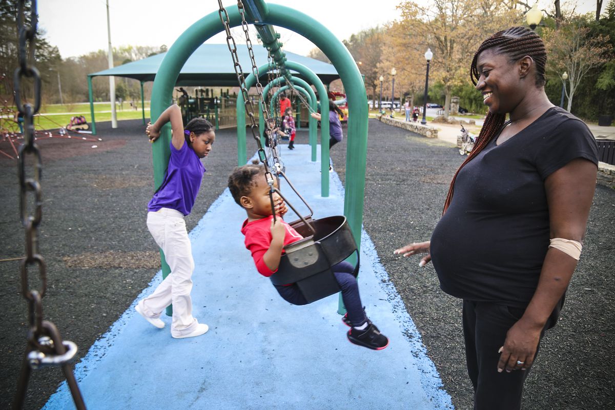 Tianna Blakely takes her girls, Corteice Prince, 9 and Anika Edmond, to the park to eat and do homework before heading to a friends home. Blakely is currently between homes and is hoping to be settled in her own apartment before giving birth to her son
