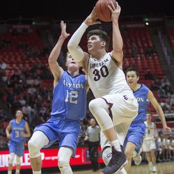 Lone Peak's Jackson Brinkerhoff takes the ball to the basket while being guarded by Layton's Truman Brown during the Lone Peak Knights' 82-47 victory against the Layton Lancers in the Class 6A state semifinals at the Jon M. Huntsman Center in Salt Lake City on Friday, March 2, 2018.