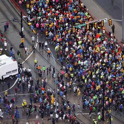 Crowds gather at the start of the Salt Lake City Marathon, Saturday, April 20, 2013. A white bomb squad truck is stationed near the start.
