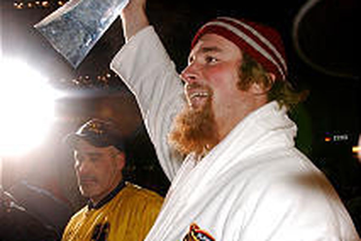 Patriots' Matt Light hoists the Vince Lombardi trophy outside Gillette Stadium in Foxboro, Mass.