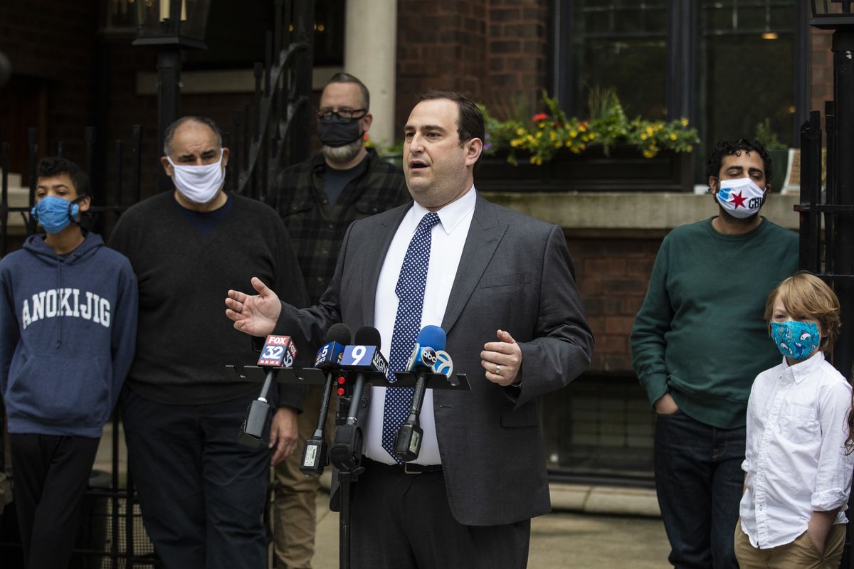 Condo owners watch as attorney Michael Cohen speaks during a press conference about a lawsuit they filed against Francis W. Parker School for allegedly carrying out a “covert scheme” to take control of their Lincoln Park building, Thursday morning, May 20, 2020.