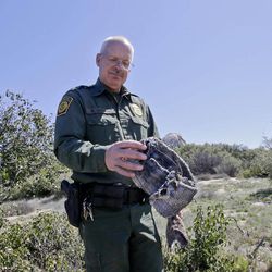 In this Monday, March 25, 2013 photo, Border Patrol agent Richard Gordon, a 23-year veteran of the agency, holds a foot wrap made of carpet and wire which illegal immigrants use to disguise their footprints while trying to avoid being tracked after entering the United States in the Boulevard area east of San Diego in Boulevard, Calif. For the past 16 years Gordon has been one of the top "sign-cutters" or trackers in the Border Patrol. 