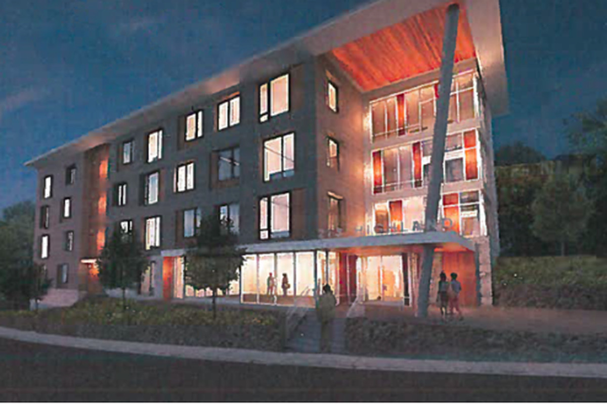 A rendering of a four-story building at night. 