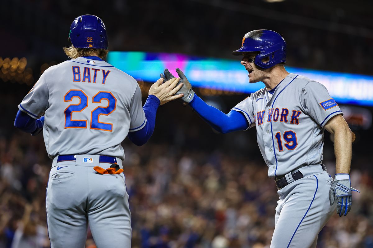 New York Mets third baseman Brett Baty and designated hitter Mark Canha celebrate after scoring during the sixth inning against the Washington Nationals at Nationals Park.&nbsp;