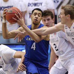 Brigham Young Cougars center Corbin Kaufusi (44) and teammate Brigham Young Cougars forward Kyle Davis (21) wrestle Creighton Bluejays guard Ronnie Harrell Jr. (4) for the ball as BYU and Creighton play in NIT quarterfinal action at the Marriott Center in Provo Tuesday, March 22, 2016.