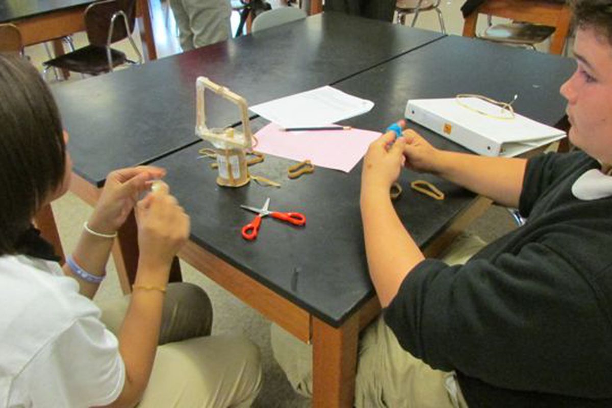 Students at Harshman Middle School, where Jack Hesser is a teacher, work on science projects.