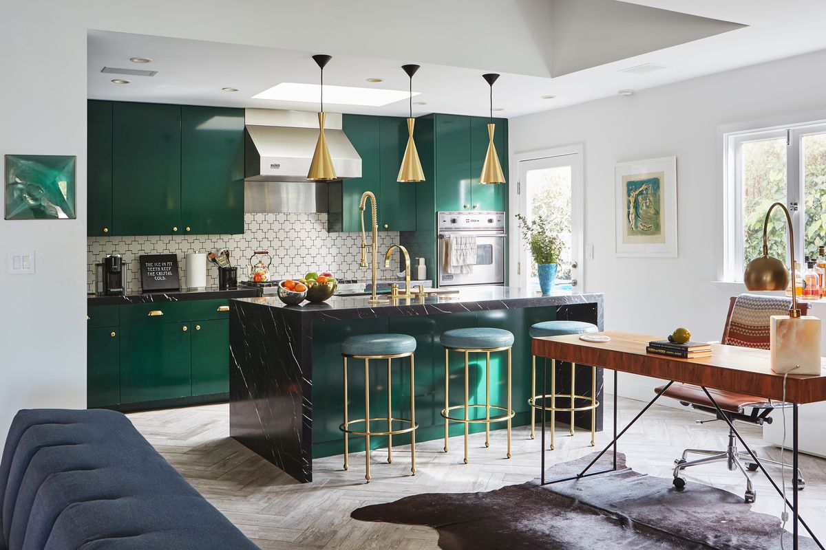 The emerald green kitchen with brass fixtures and detailing.