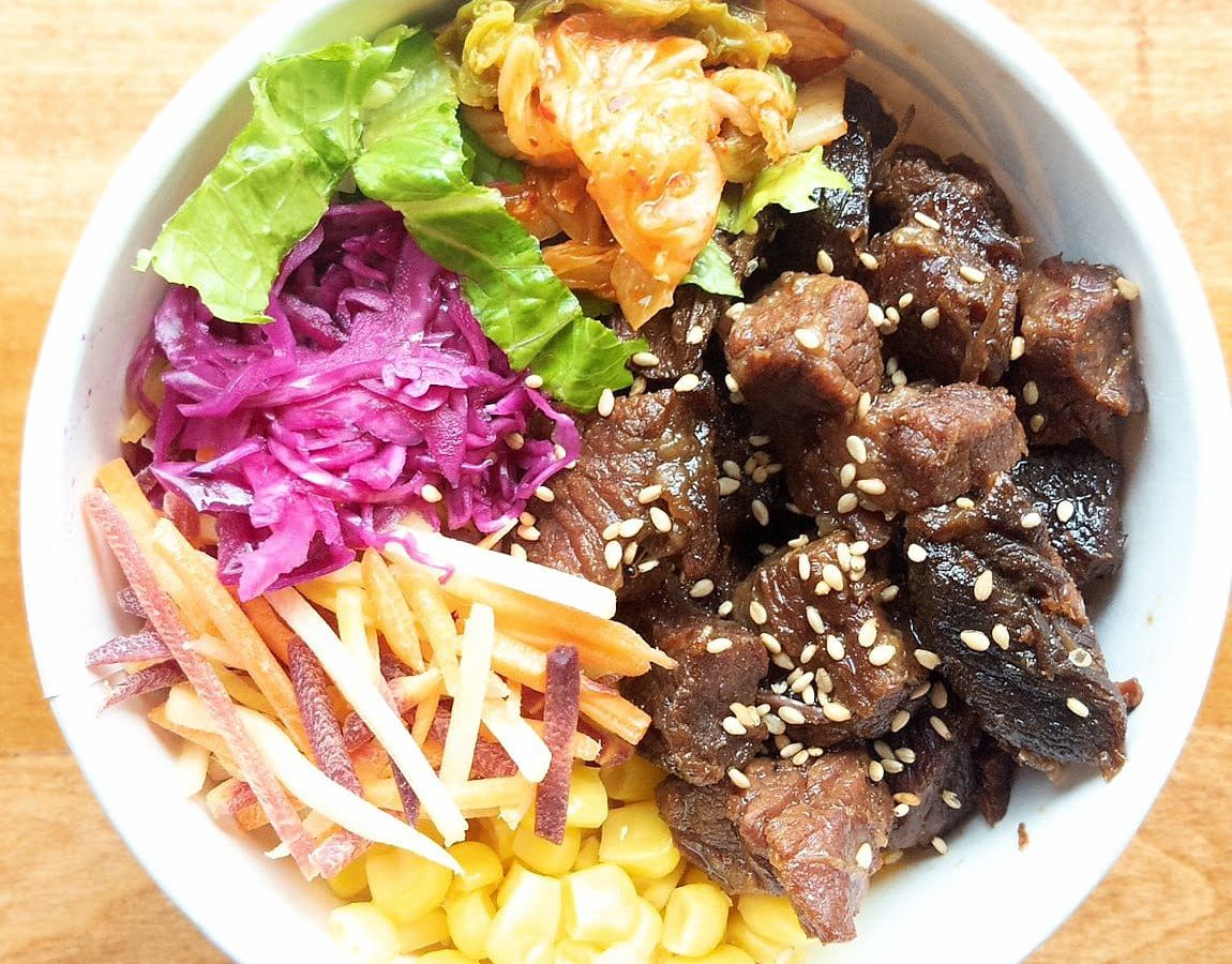 Beef short ribs, kimchi, pickled cabbage, corn, romaine, golden beets and carrots over brown rice&nbsp;