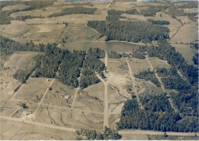 An aerial photo of a blank slate of land with trees.