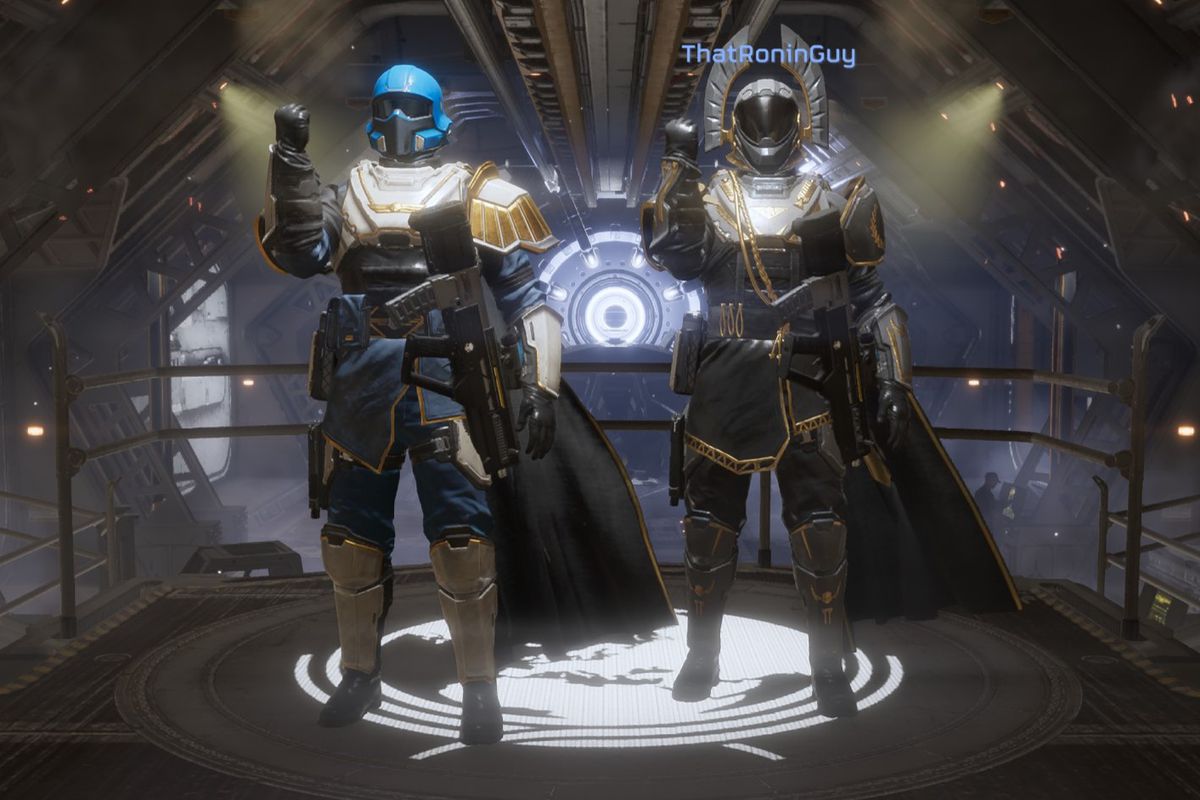 Two helldivers standing next to each other in Helldivers 2. They have small spotlights on them because they just had a great victory. They’re also wearing two different suits of armor.