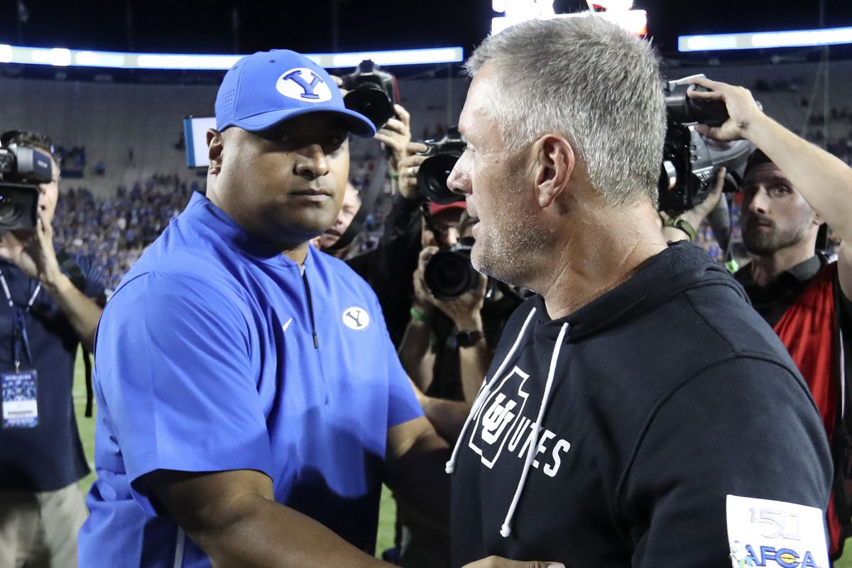 BYU head coach Kalani Sitake and Utah head coach Kyle Whittingham congratulate each other after Utah defeated BYU 30-12 at LaVell Edwards Stadium in Provo on Friday, Aug. 30, 2019.