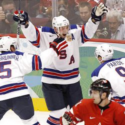 USA's Brian Rafalski, center, celebrates his second goal against Canada with teammates Jamie Langenbrunner, left, and Zach Parise during first period men's ice hockey action at the 2010 Winter Olympic Games in Vancouver Sunday. The United States won 5-3.